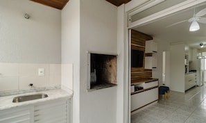 A modern kitchen with a built-in oven, a sink, and a wooden countertop.