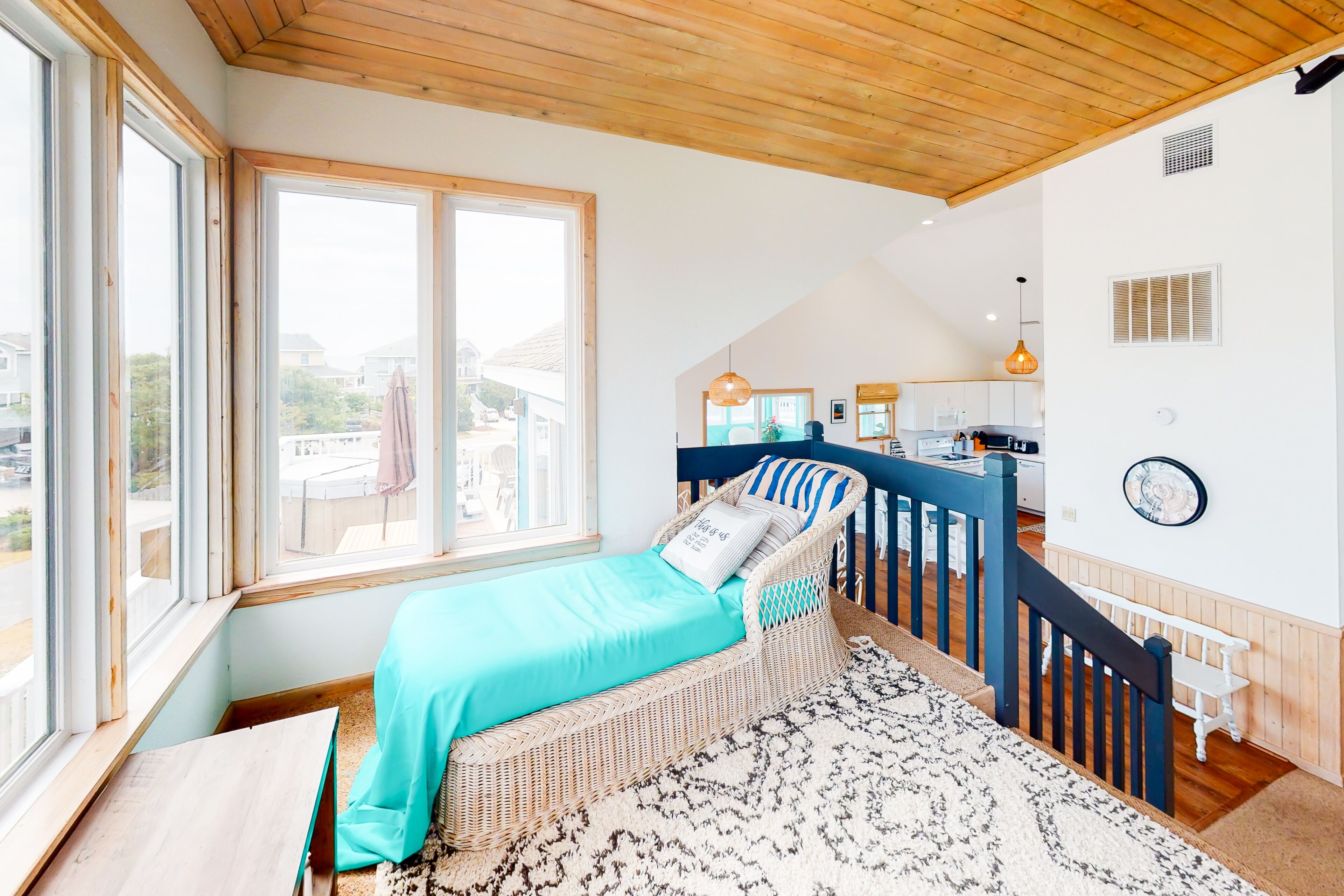 A room with a bed, a dining area, and a kitchen.