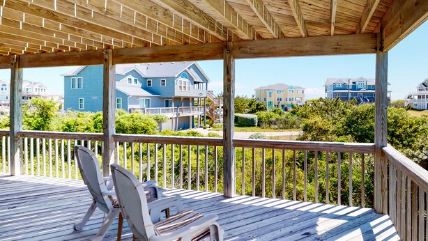 A wooden deck with two white chairs and a wooden railing. - 4BR | Private Pool | Fireplace | Balcony | W/D (Corolla)