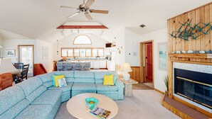 A spacious living room with a large sectional sofa, a coffee table, and a fireplace. - 4BR | Private Pool | Fireplace | Balcony | W/D (Corolla)