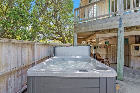 A hot tub in a wooden deck area with a wooden fence and trees in the background. - Private Pool, Hot Tub, Dog-Friendly (Corolla)