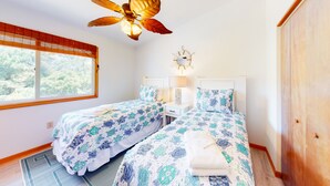A bedroom with two beds, a ceiling fan, a window with blinds, and a wooden wardrobe. - 2BR | Pool | Deck | Tennis | W/D (Duck)