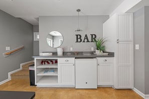 A compact kitchen with a built-in refrigerator, a sink, and a countertop with a mirror. - Walk to Beach 5BR Waterview Dog Friendly | Pool (Duck)
