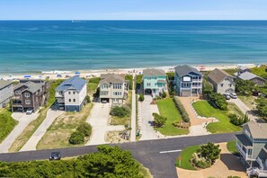 A coastal residential area with houses, a beach, and a clear view of the ocean. - Oceanside 3BR, walk to beach & boardwalk (Duck)