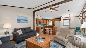 A compact living space with a kitchenette, a dining area, and a seating area with a coffee table.