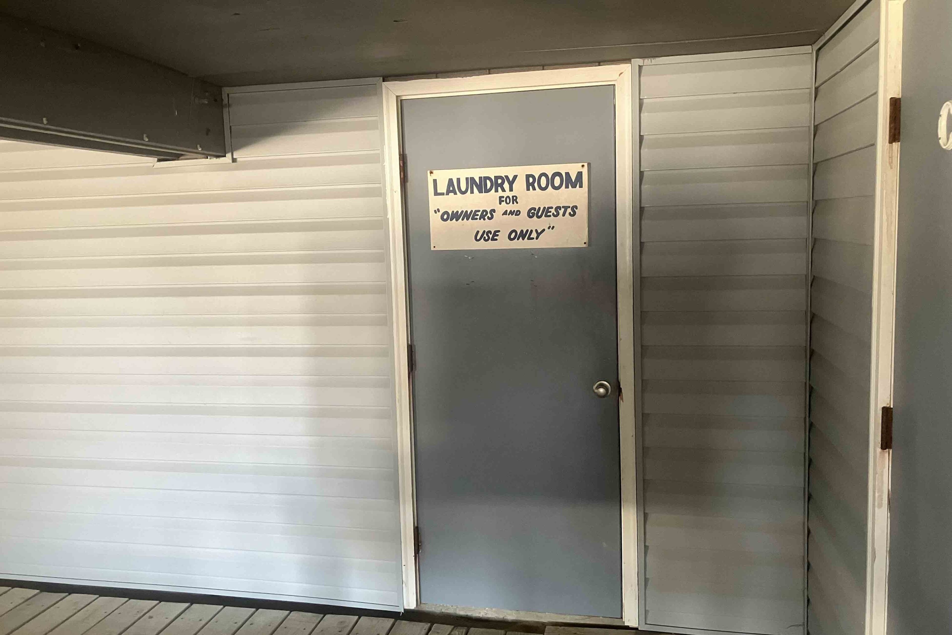 A closed door with a sign indicating a laundry room for owners and guests use only.