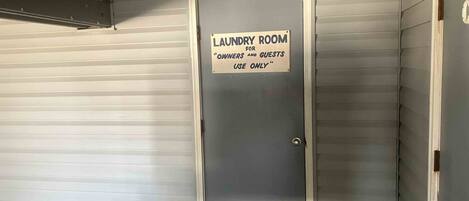 A closed door with a sign indicating a laundry room for owners and guests use only.