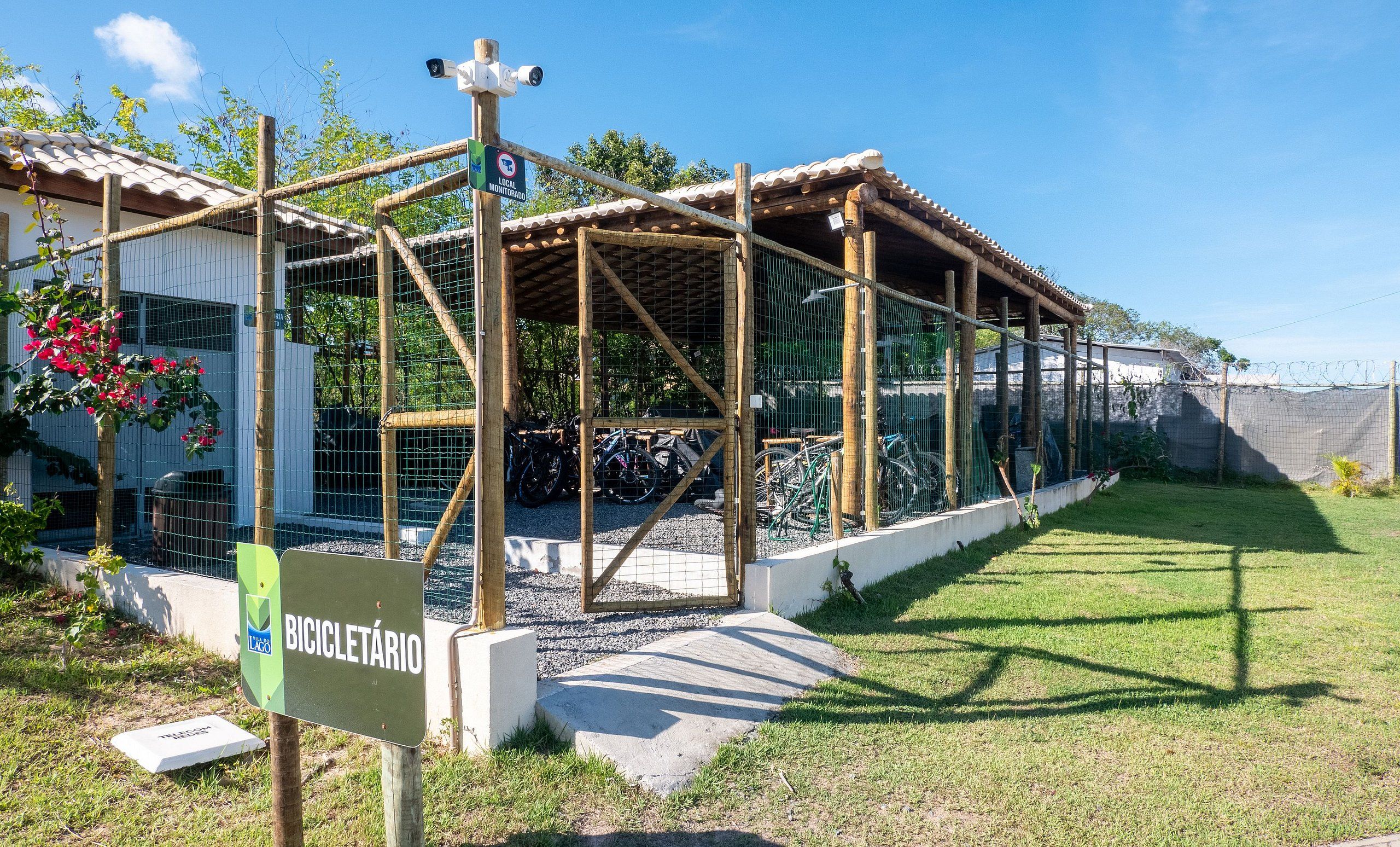 A covered bicycle parking area with a sign indicating it is a local monitor station.