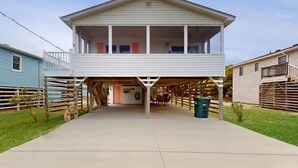 A two-story house with a covered front porch and a garage.