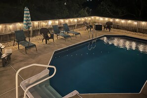 A swimming pool with lounge chairs and a wooden deck. - 5BR Dog Friendly | Private Pool | Hot Tub (Corolla)
