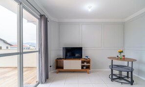 Basic Apartment | Living area | 32-inch Smart TV with digital channels - 2-Bedroom Apartment with Barbecue 270m from the Beach CCC0302 (Florianópolis)