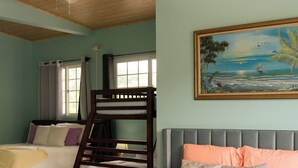 A hotel room with two beds, a painting of a tropical scene, and a window with curtains. - Beautiful Beach Apartment in Veracruz at 20 min from Pamama City (Panamá)