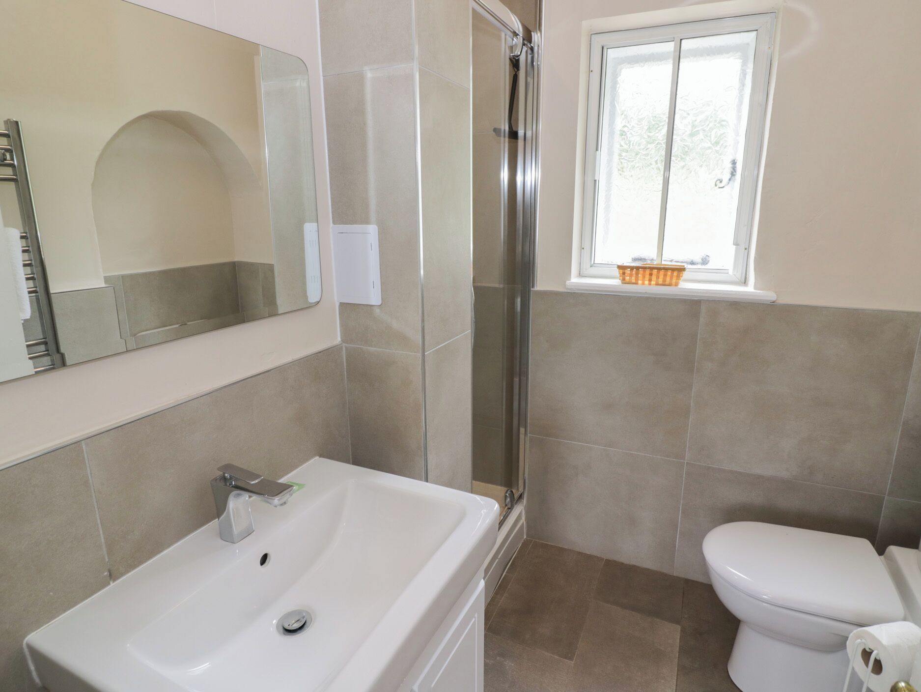 A bathroom with a shower, toilet, and sink.