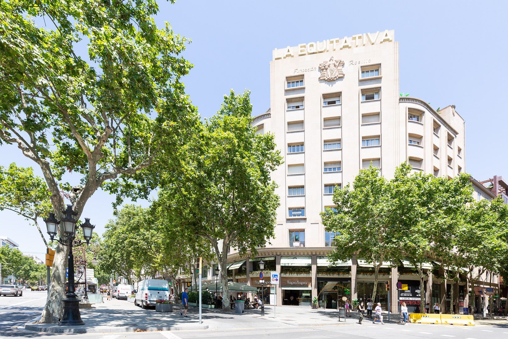 A multi-story building with a prominent sign reading 'LA EQUITATIVA.'