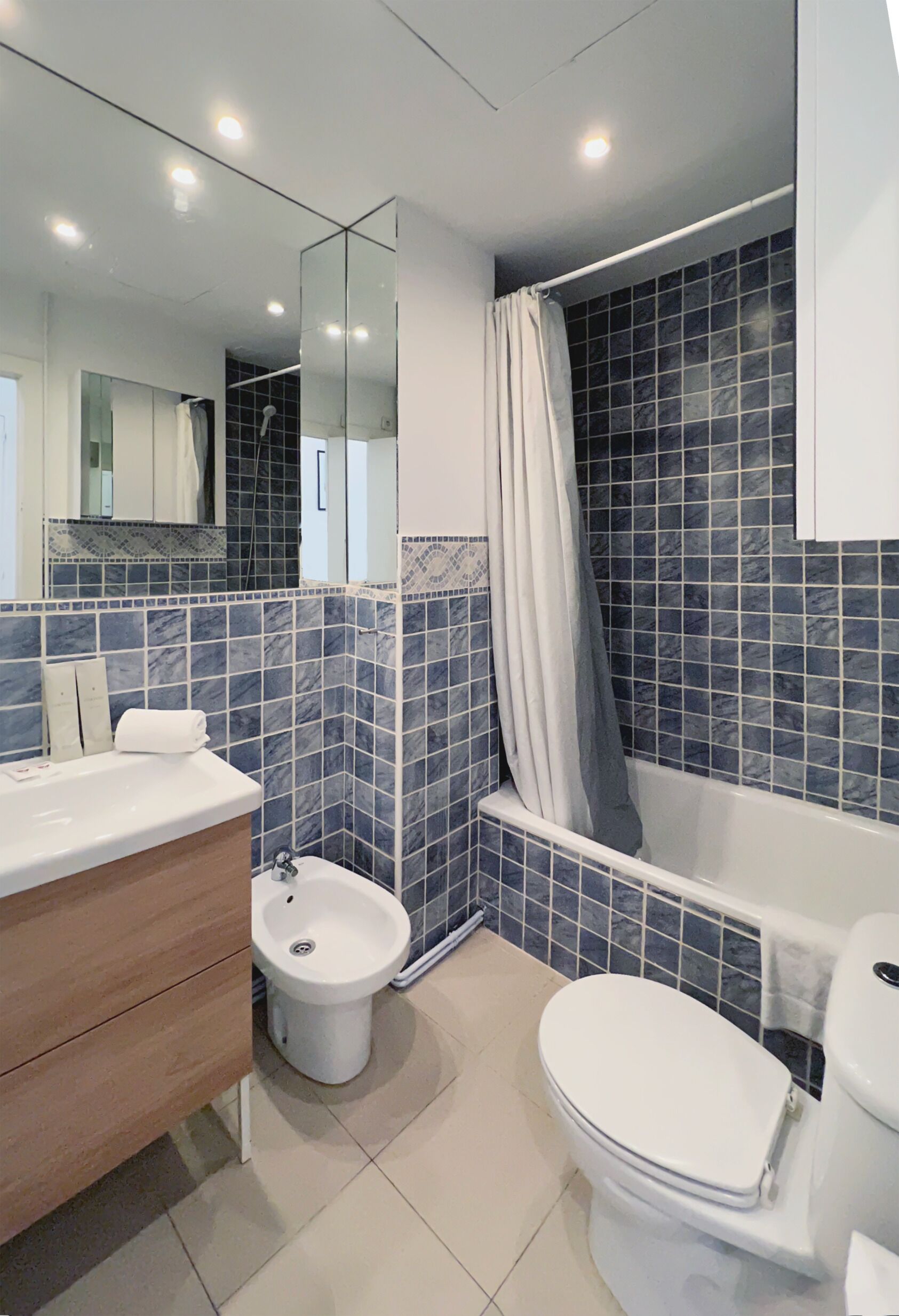 Un baño moderno con bañera, inodoro, bidé y tocador.