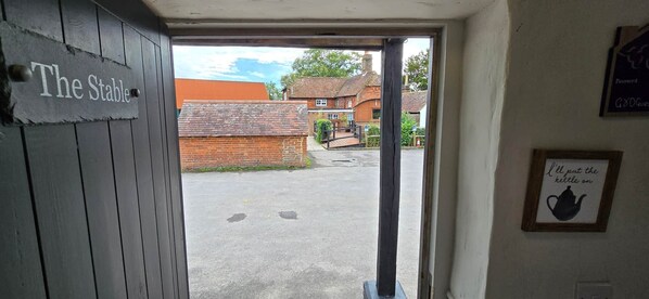 An entrance to a building with a sign reading "The Stable". - The George & Dragon Pub - The Stable (Horsham)