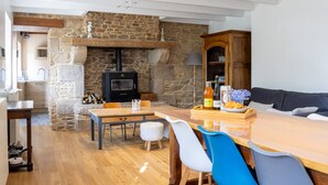 Una habitación acogedora con chimenea de piedra, muebles de madera y un comedor.