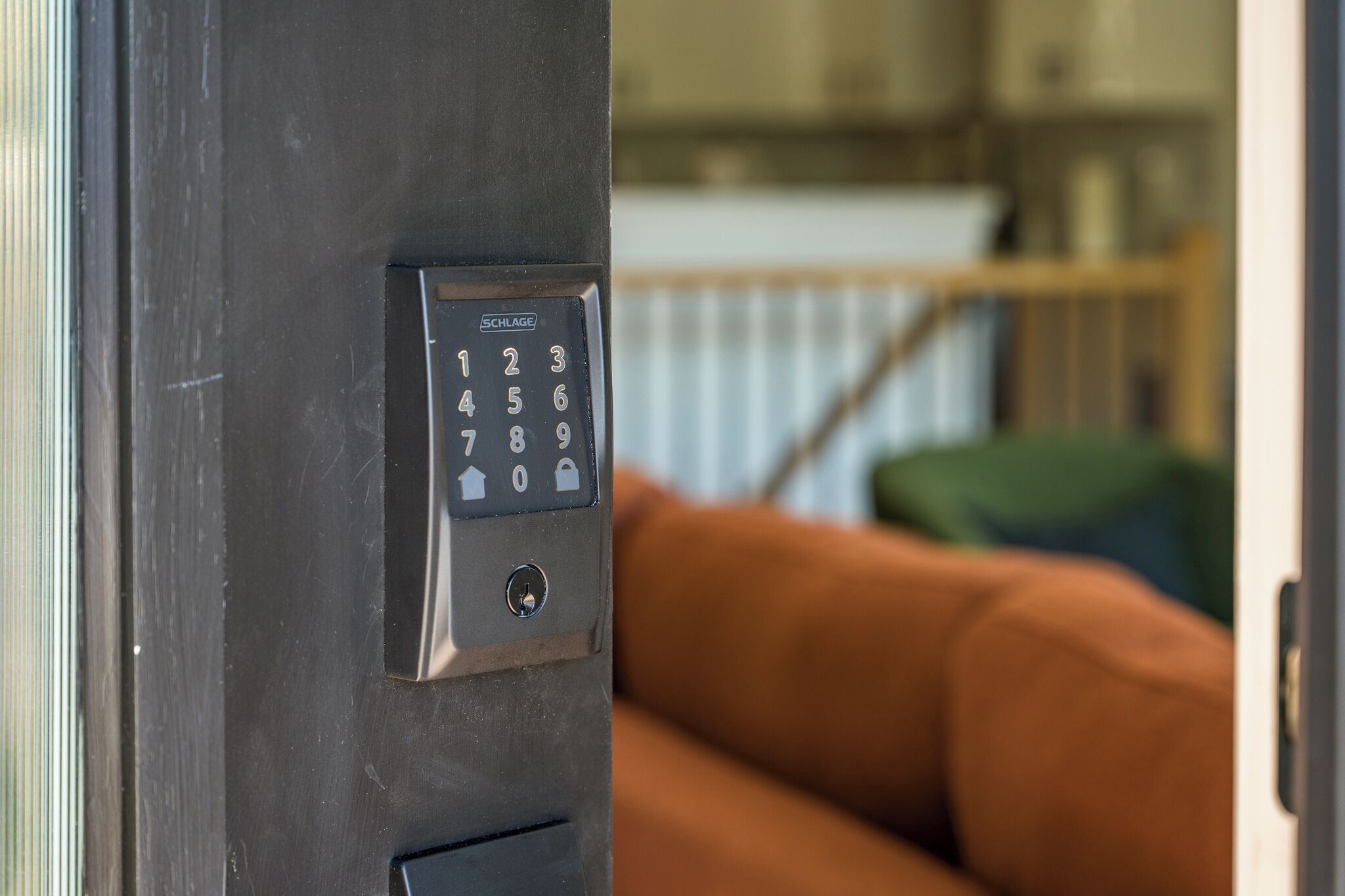 A door with a numeric keypad lock, a metal handle, and a keyhole.
