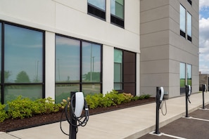 A modern building with large windows and a Tesla charging station. - La Quinta Inn & Suites By Wyndham Jackson (Jackson)
