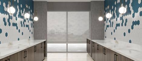 A modern bathroom with two sinks, wooden cabinets, and a large window with a view.