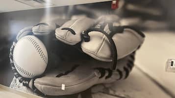 A baseball glove and a baseball on a display.