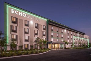 A modern hotel building with the name 'Echosuites' prominently displayed. It features a symmetrical facade with evenly spaced windows and a central entrance. - Echo Suites Extended Stay By Wyndham Naples (Naples)