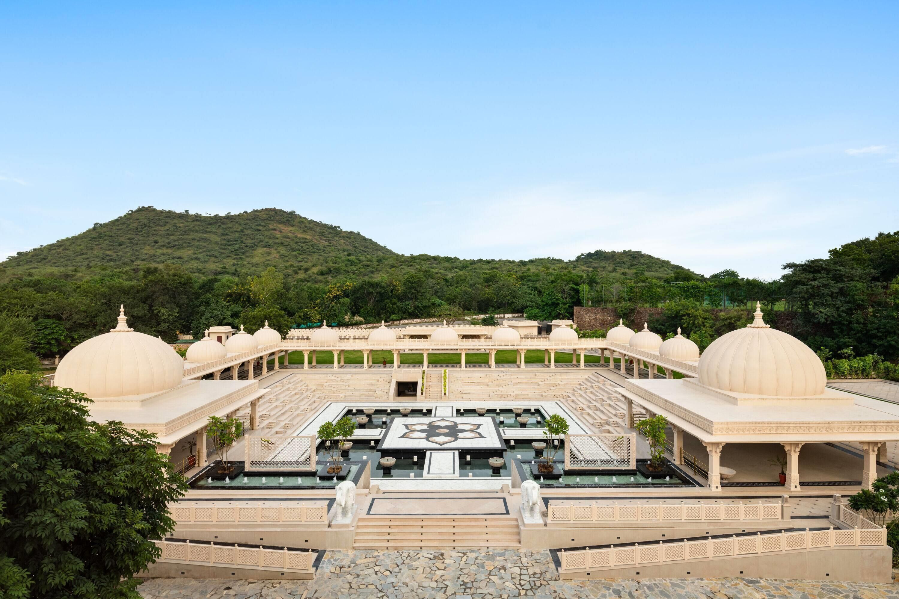 A large, open courtyard with multiple domed structures and a central fountain.