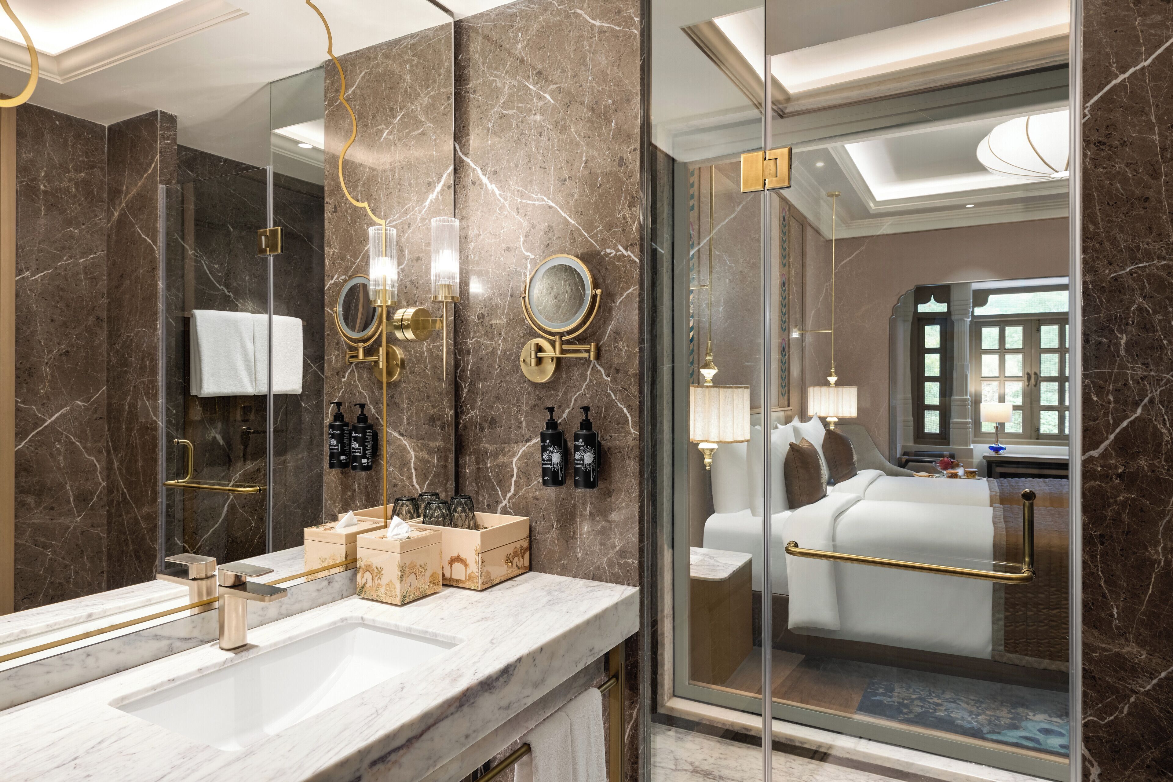 A modern bathroom with a large mirror, two sinks, and a glass shower enclosure.