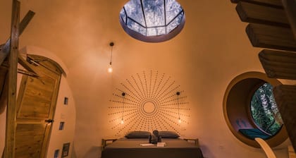 Dome shaped bungalow in a lush tropical forest, steps away from ocean views.