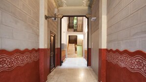A hallway with patterned walls and a staircase leading to an upper level. - Stay U-nique Apartments Villarroel (Barcelona)