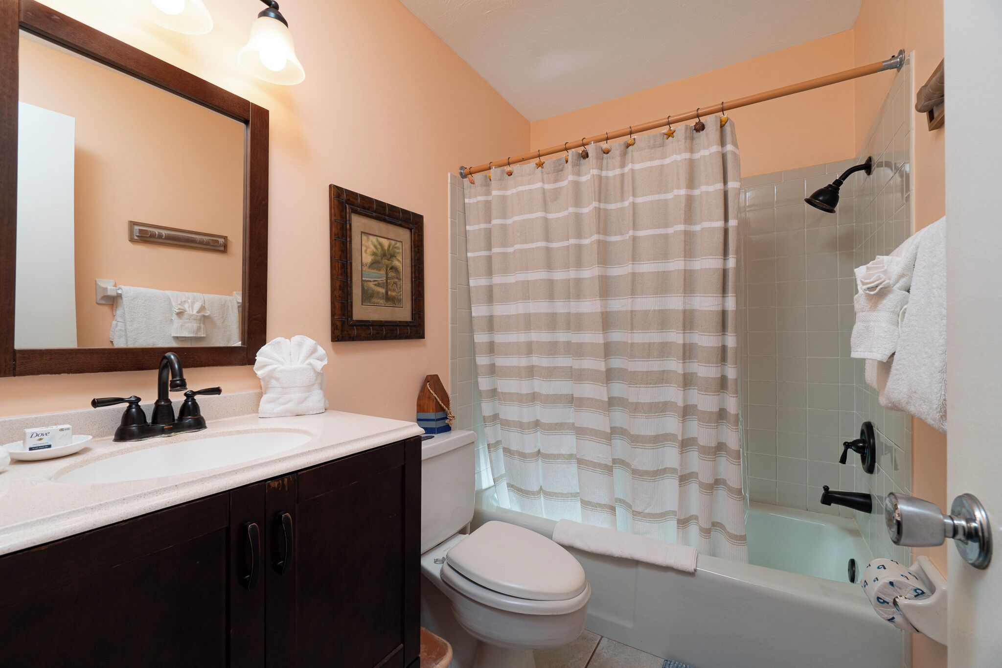 A bathroom with a sink, toilet, and shower.