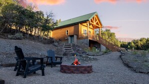A log cabin with a porch and a fire pit. - National Parks - Cowboy Hot tub and UFO Sightings (Alton)
