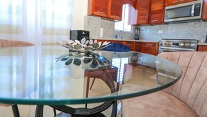 A modern kitchen with wooden cabinets, a stainless steel microwave, and a granite countertop. - Lovely 2 Bd-2Bath Apt w. A|C Garage & Rooftop (San Cristobal)