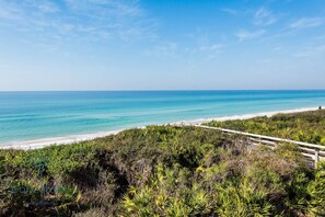 A coastal landscape with a beach, dense vegetation, and a clear blue sky. - "Casita in Paradise 30A" 2BR/3BA/Seacrest Beach Lagoon Pool (Seacrest Beach)