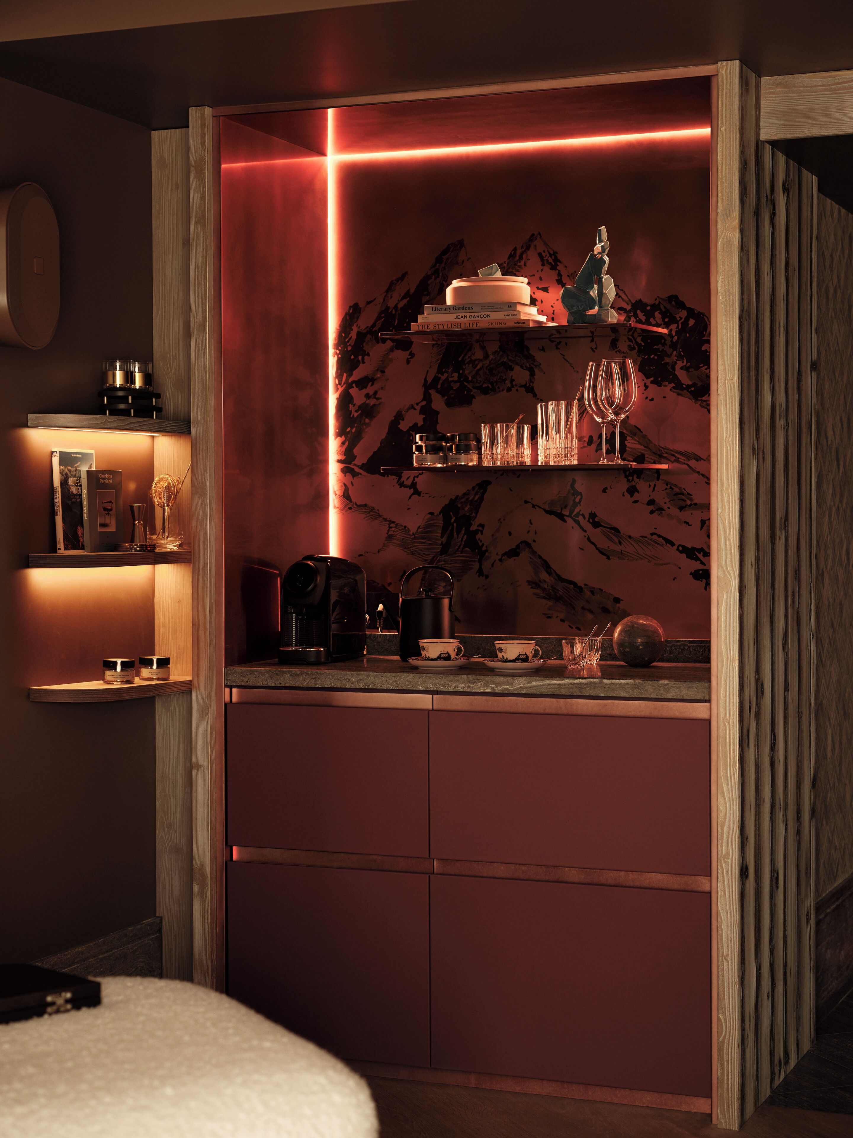 A compact kitchen with a wooden countertop, a coffee machine, and a kettle.