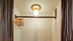 A compact, modern bathroom with a built-in shower, a wooden bench, and a towel rack. - Breakfast Incl | Caribbean Escape | Ocean Views (Buck Island)