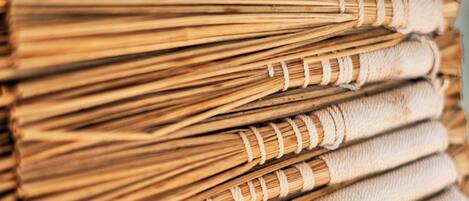 A close-up of a stack of neatly tied, cylindrical objects, likely brooms or similar items.