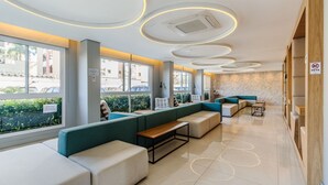 A modern waiting area with seating, large windows, and a no-pets sign. - Studio in Building With Pool Con1206 (Porto Alegre)