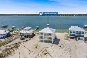 A beachfront property with multiple buildings, a dock, and a clear view of the water. - Beach Blessing- Pool Elevator Sleeps 16 SIX Bedrooms 6 Baths (Gulf Shores)