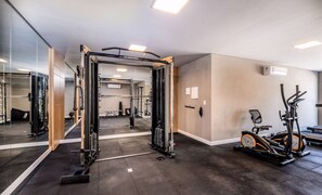 A gym with a squat rack, mirrors, a treadmill, and a wall-mounted air conditioner. - Apt w/ BBQ 650 m From the Beach Ingleses Cci003 (Florianópolis)