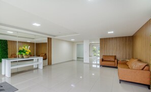 A spacious, modern living area with a white console table, a brown leather sofa, and a glass coffee table. - Apt in Canela Facing Duck Lake Cbl307 (Canela)