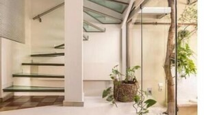 A modern staircase with glass railings and a checkered floor. - Evangelia3 Attic with Amazing View Patio (Athens)