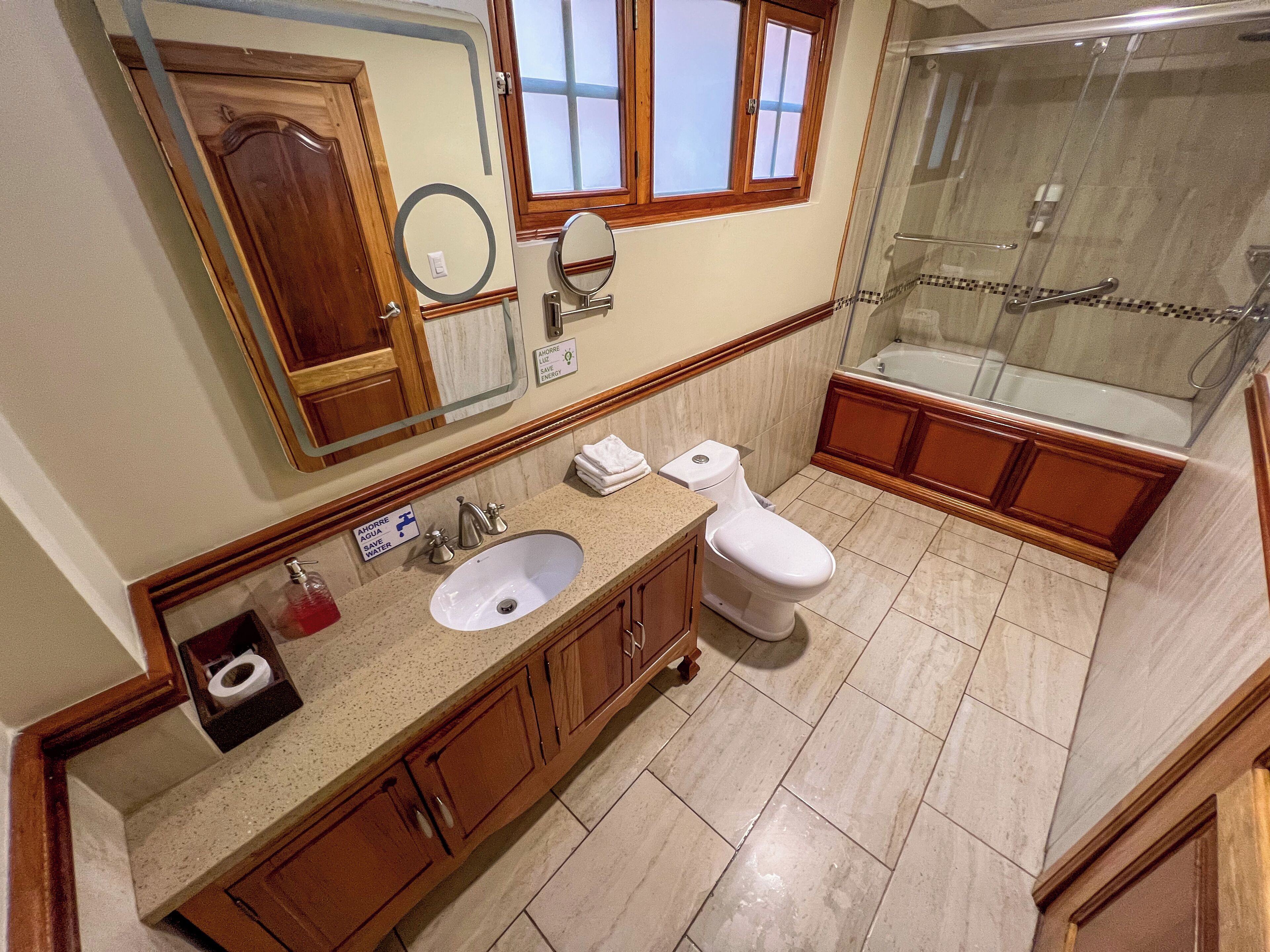 A bathroom with a sink, toilet, and shower.