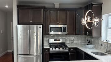 Microwave, stovetop, dishwasher, cookware/dishes/utensils
