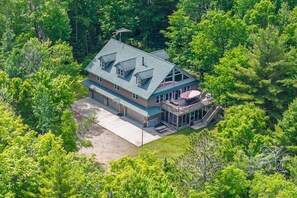 A large two-story house with a deck and a covered porch.