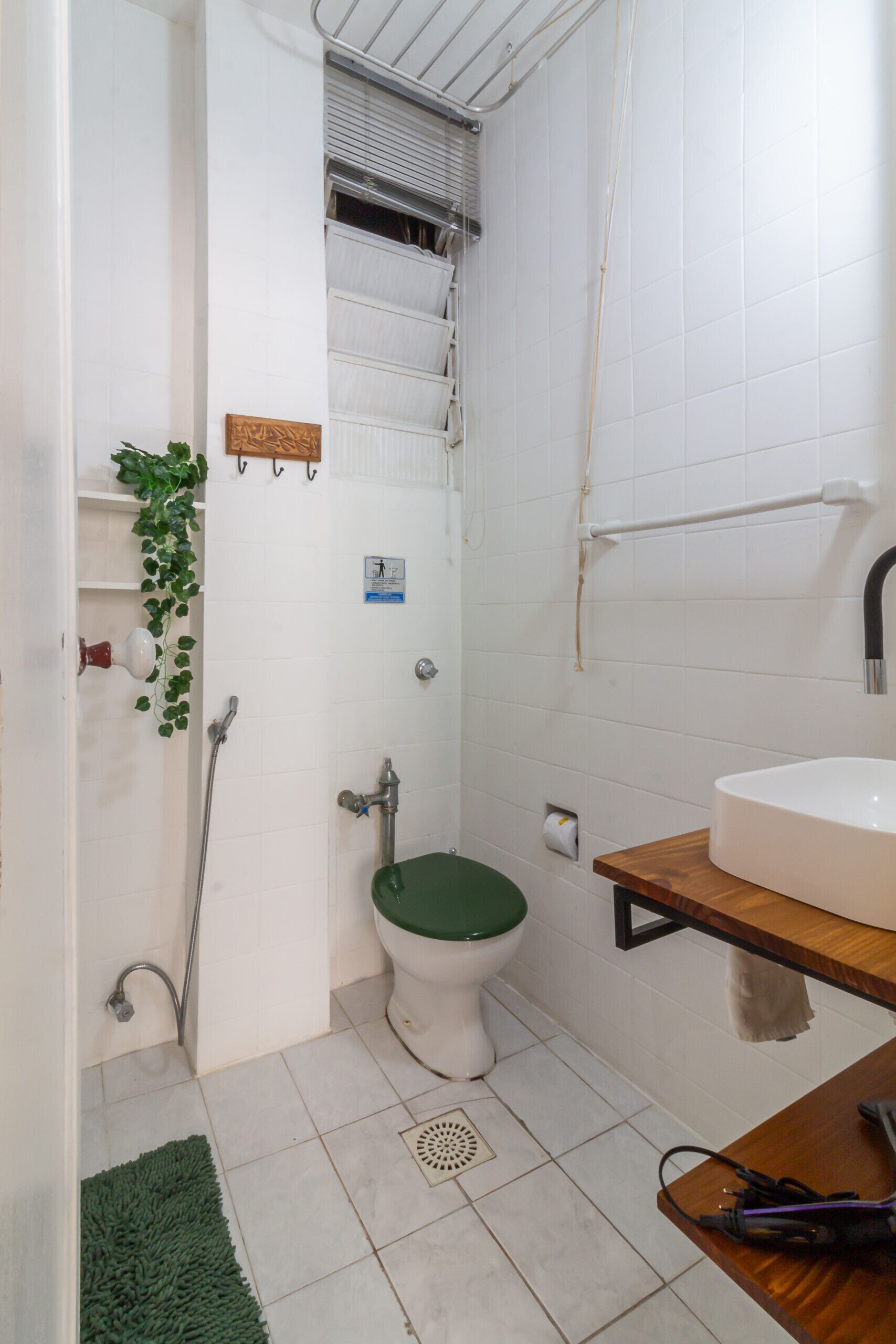 A bathroom with a toilet, shower, and sink.