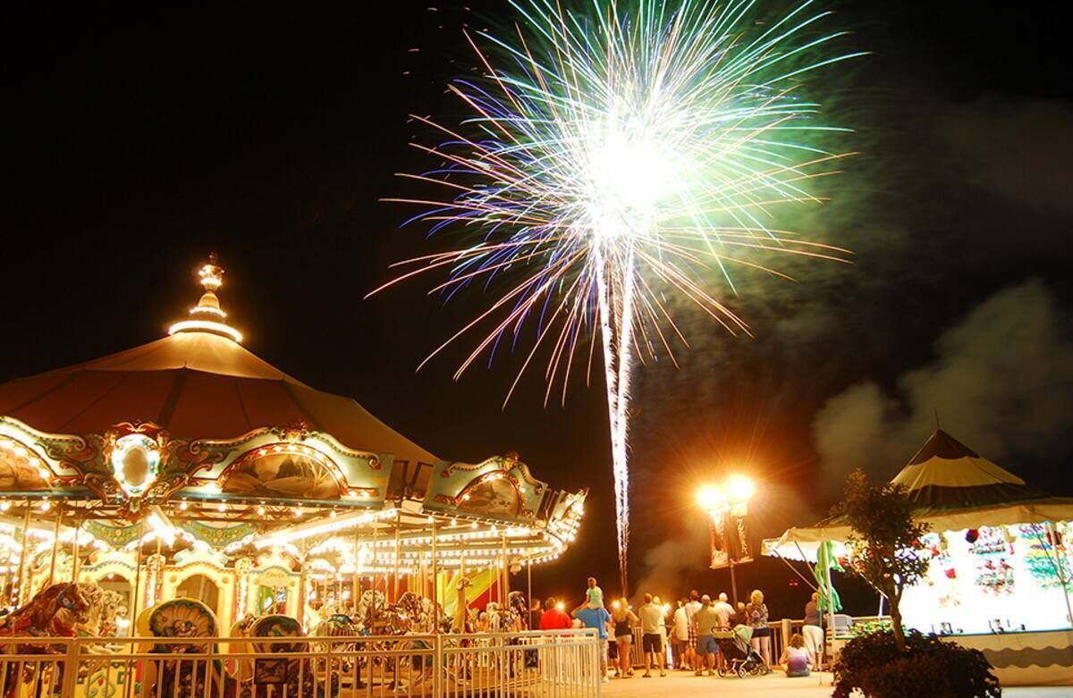 A carousel with a dome-shaped roof and a bright light at the top.