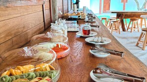 A buffet table with various food items and utensils. - Atins Beach House (Barreirinhas)