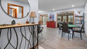A dining area with a pool table, chairs, and a red cabinet. - Stay and Play HSV (Hot Springs)