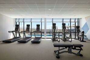 A gym with treadmills, elliptical machines, and a bench. - Springhill Suites By Marriott Abilene (Abilene)